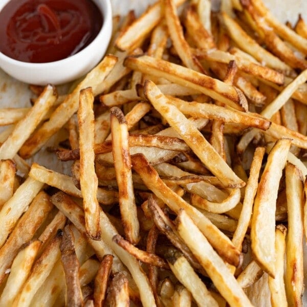 A pile of oven baked fries on the counter.