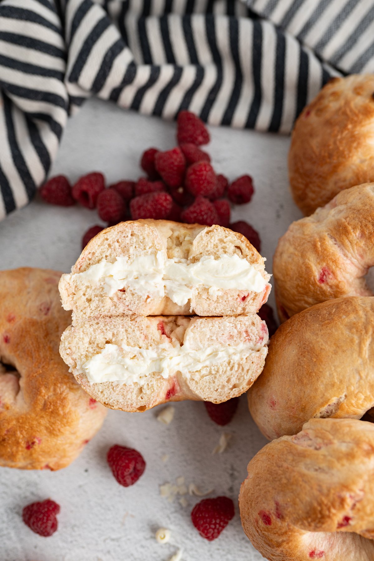 A raspberry bagel cut in half and stuffed with cream cheese. 