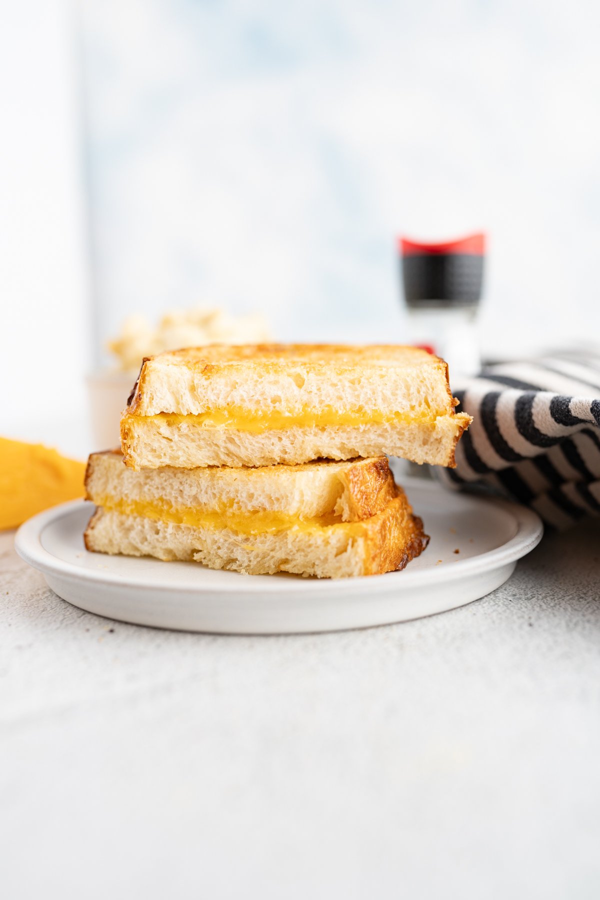 Golden grilled cheese in air fryer on plate. 