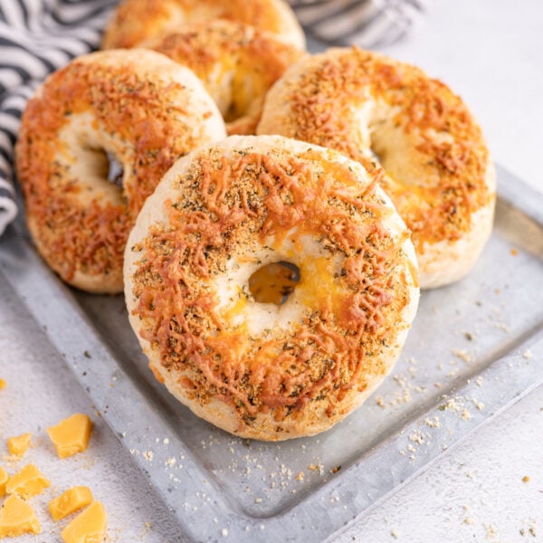 A plate of 4 italian herb and cheese bagels.