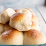 A close up of a pile of fresh dinner rolls.