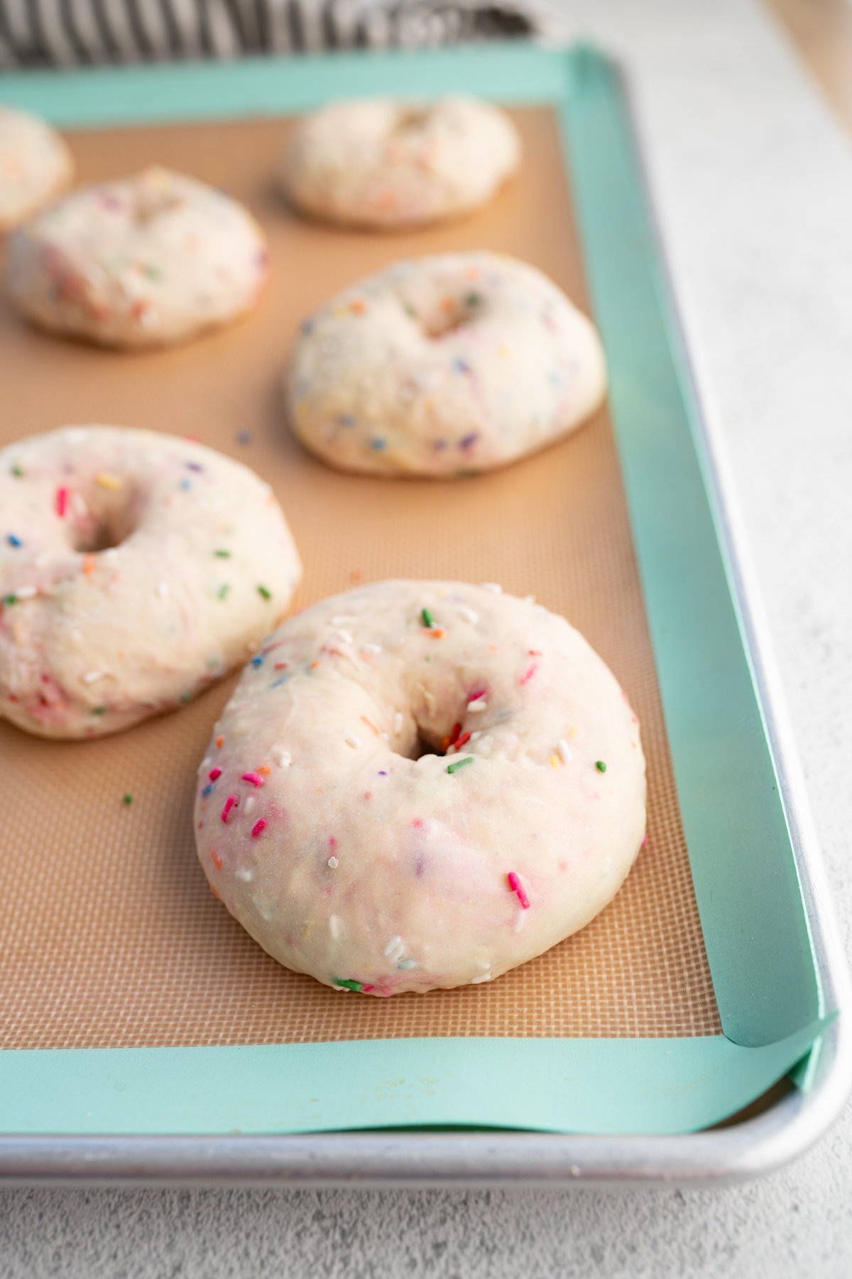 Funfetti bagels on a sheet pan prior to being baked. 