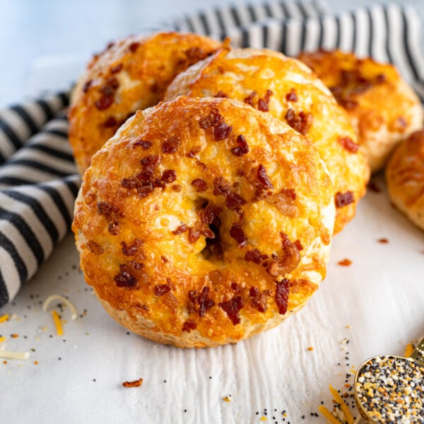 Close up of a horizontal stack of cheddar bacon everything bagels.