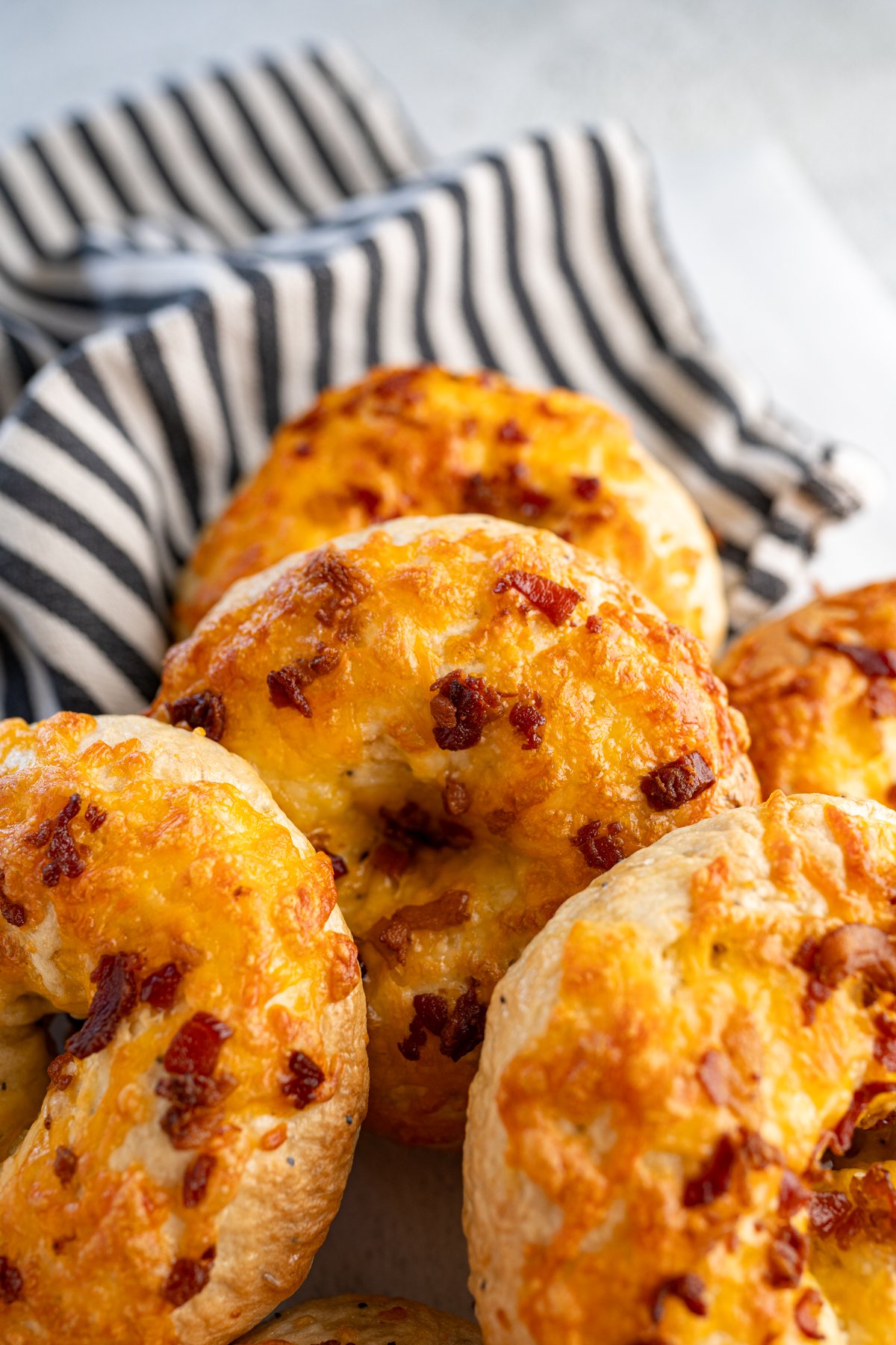 Close up of a basket of cheddar bacon bagels. 
