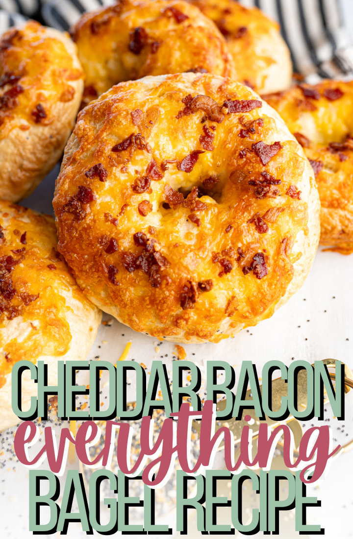 Close up of a horizontal stack of cheddar bacon everything bagels. Across the bottom it says "cheddar bacon everything bagel recipe" 