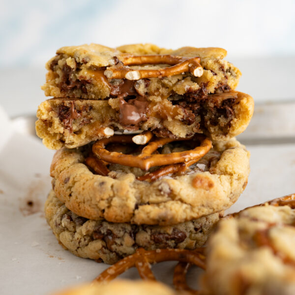 A salted caramel pretzel cookie broken in half revealing the inside of the cookie.