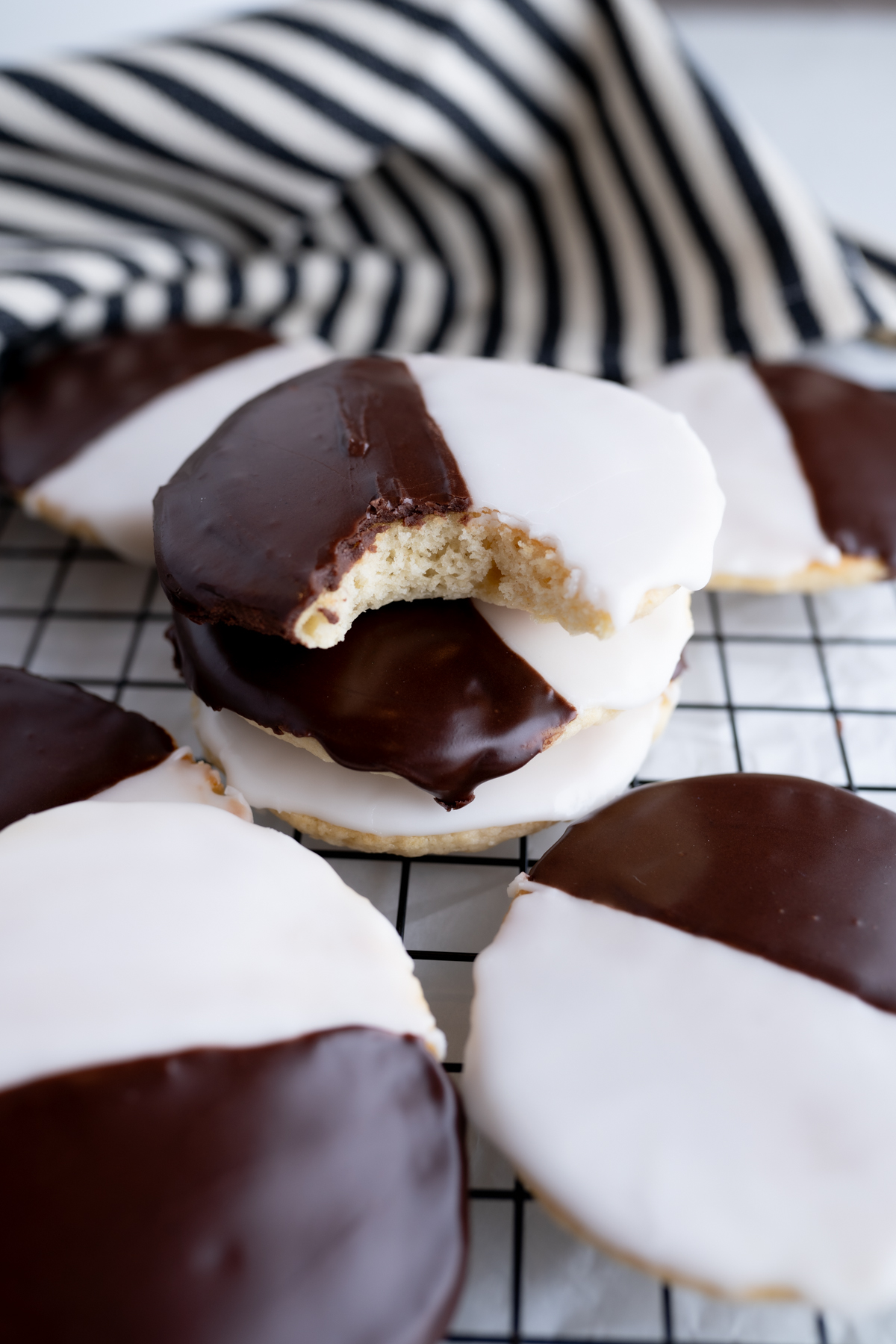 A cakey cookie with black and white frosting with a bite taken out of it.