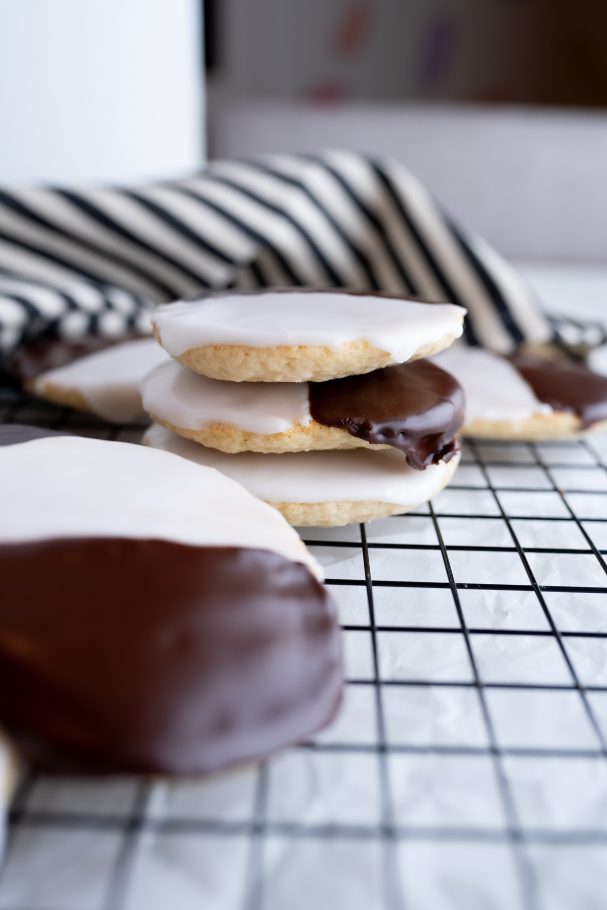 Side view of a stack of black and white cookies. 