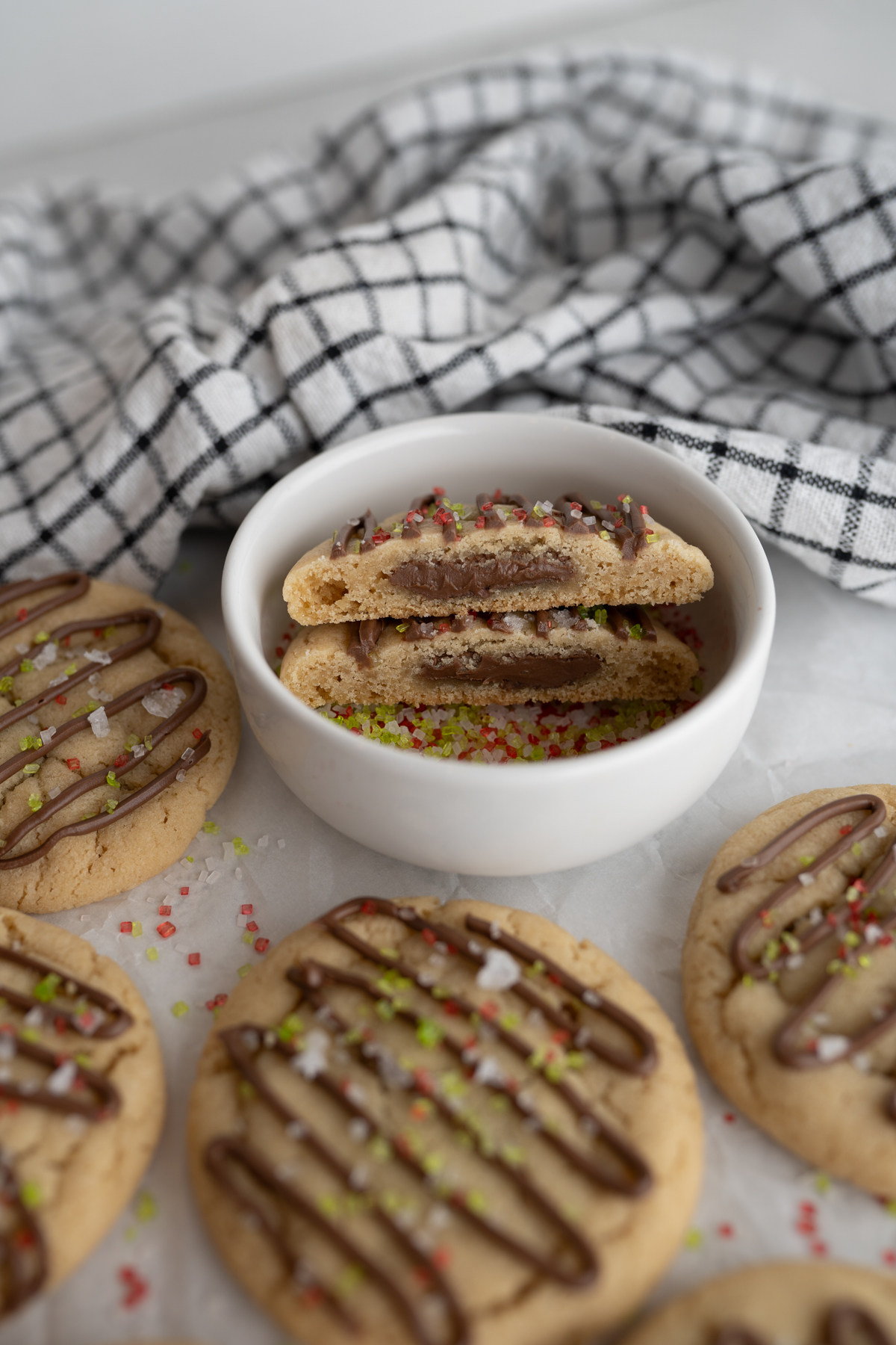 The crumbl hazelnut cookie copycat in a bowl of sprinkles. 