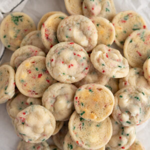 A pile of small white chocolate sprinkle cookies.