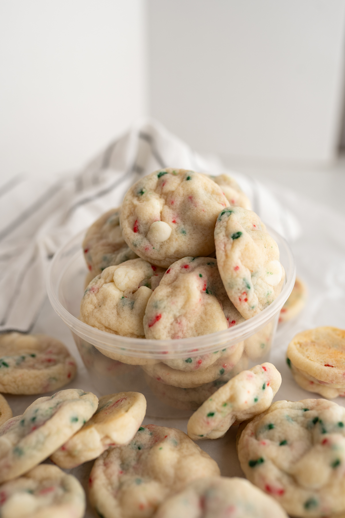 Side view of a plastic container filled with Christmas cookies (sugar sprinkle).