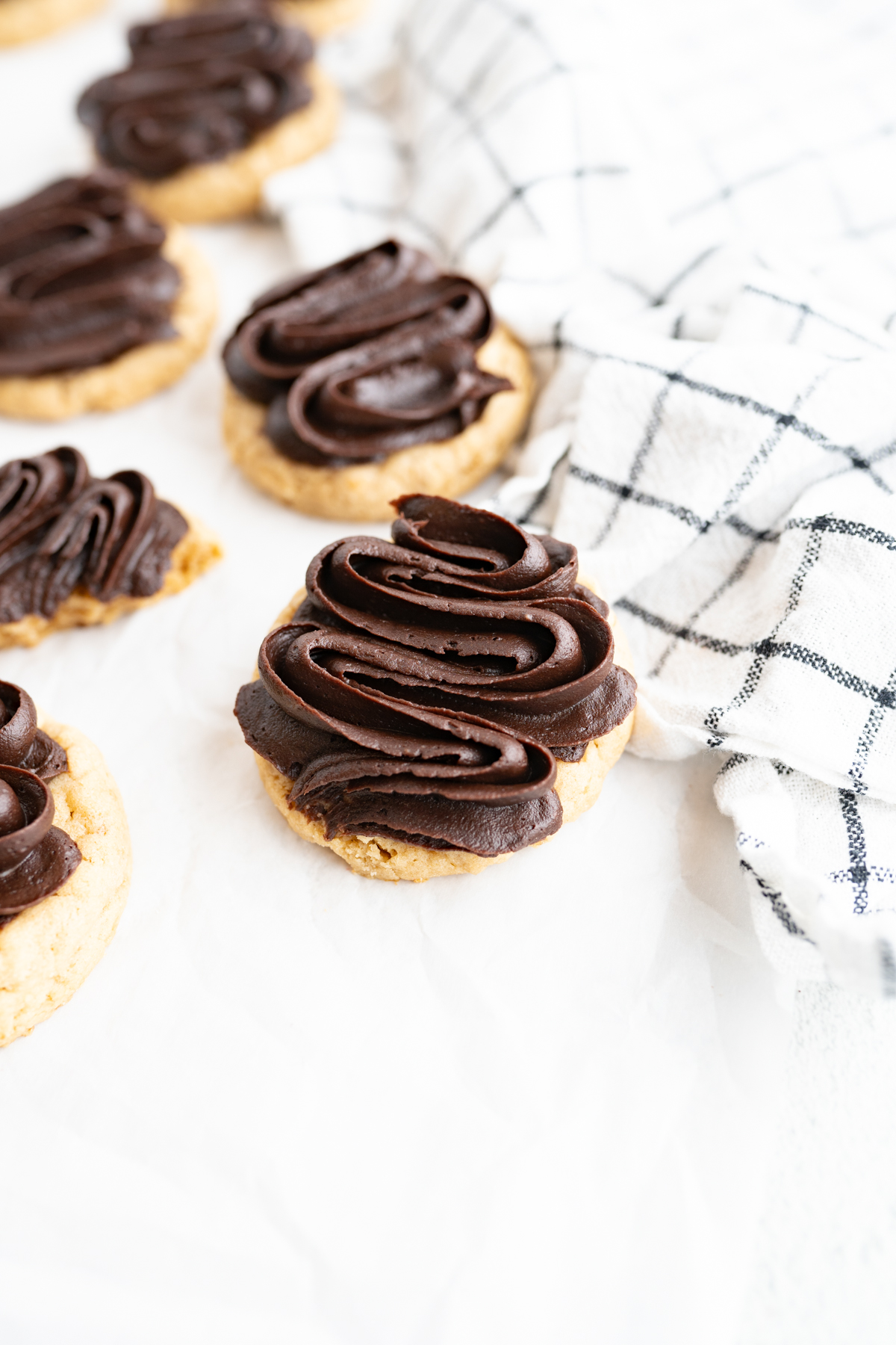 Fudge frosting swirled on a cookie. 