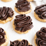 Peanut butter cookies topped with a fudge frosting.