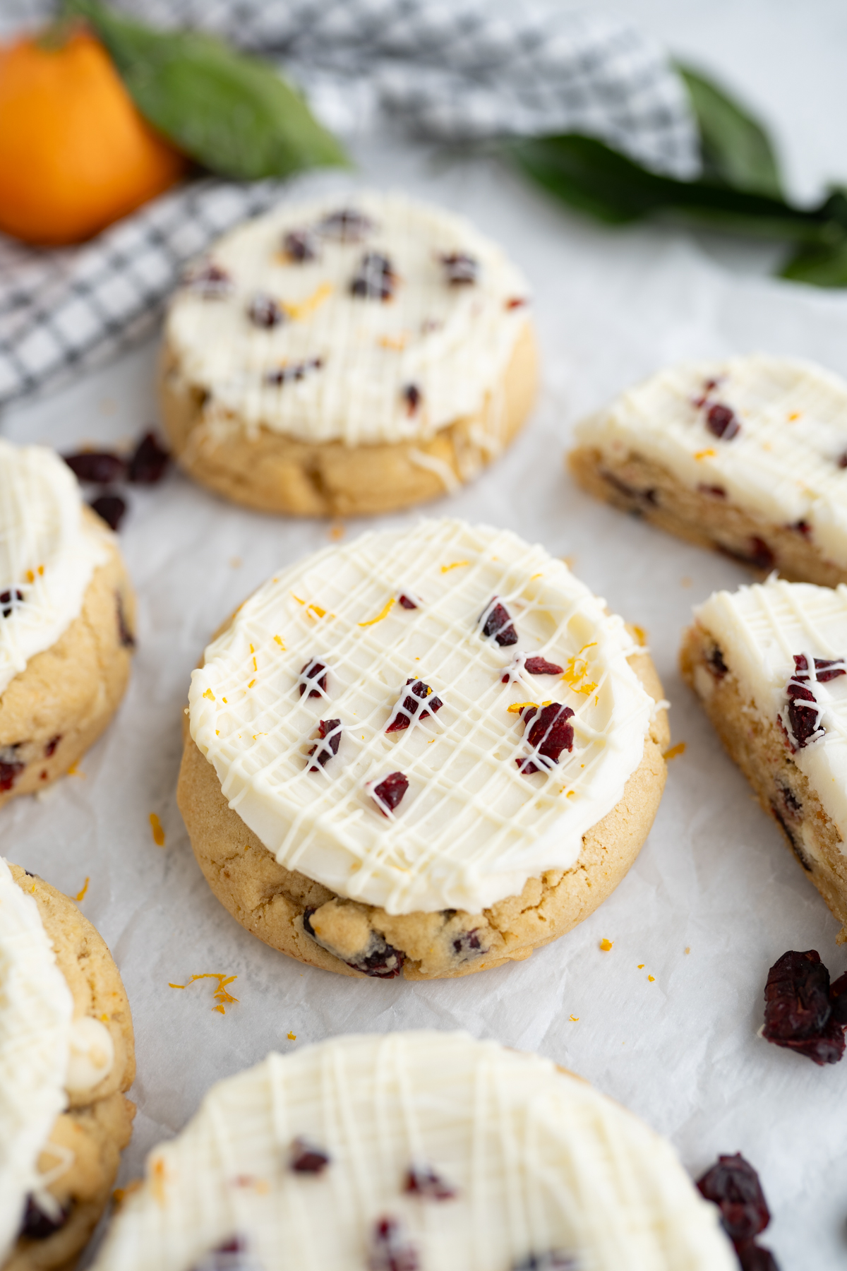 Aerial view of blondie cookies stuffed with orange, cranberries and white chocolate. Topped with frosting? 