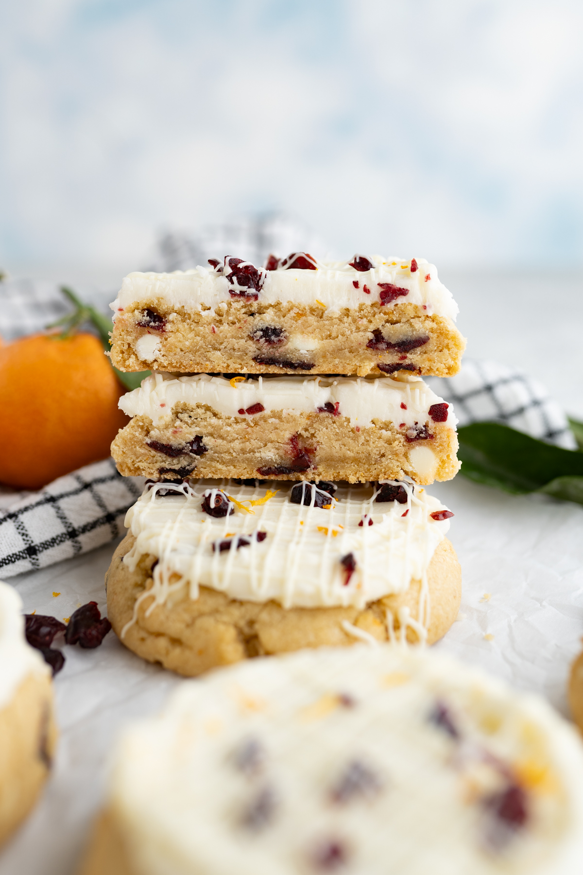 A stack of cranberry bliss cookies inspired by Starbucks. One cookie cut in half. 