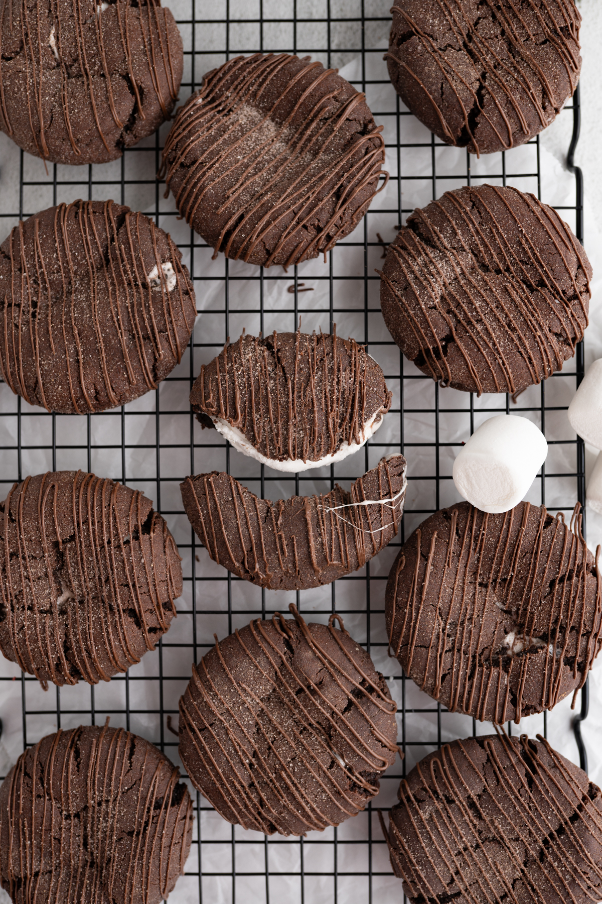 Aerial view of hot cocoa bomb cookies on a wire cooling rack. 