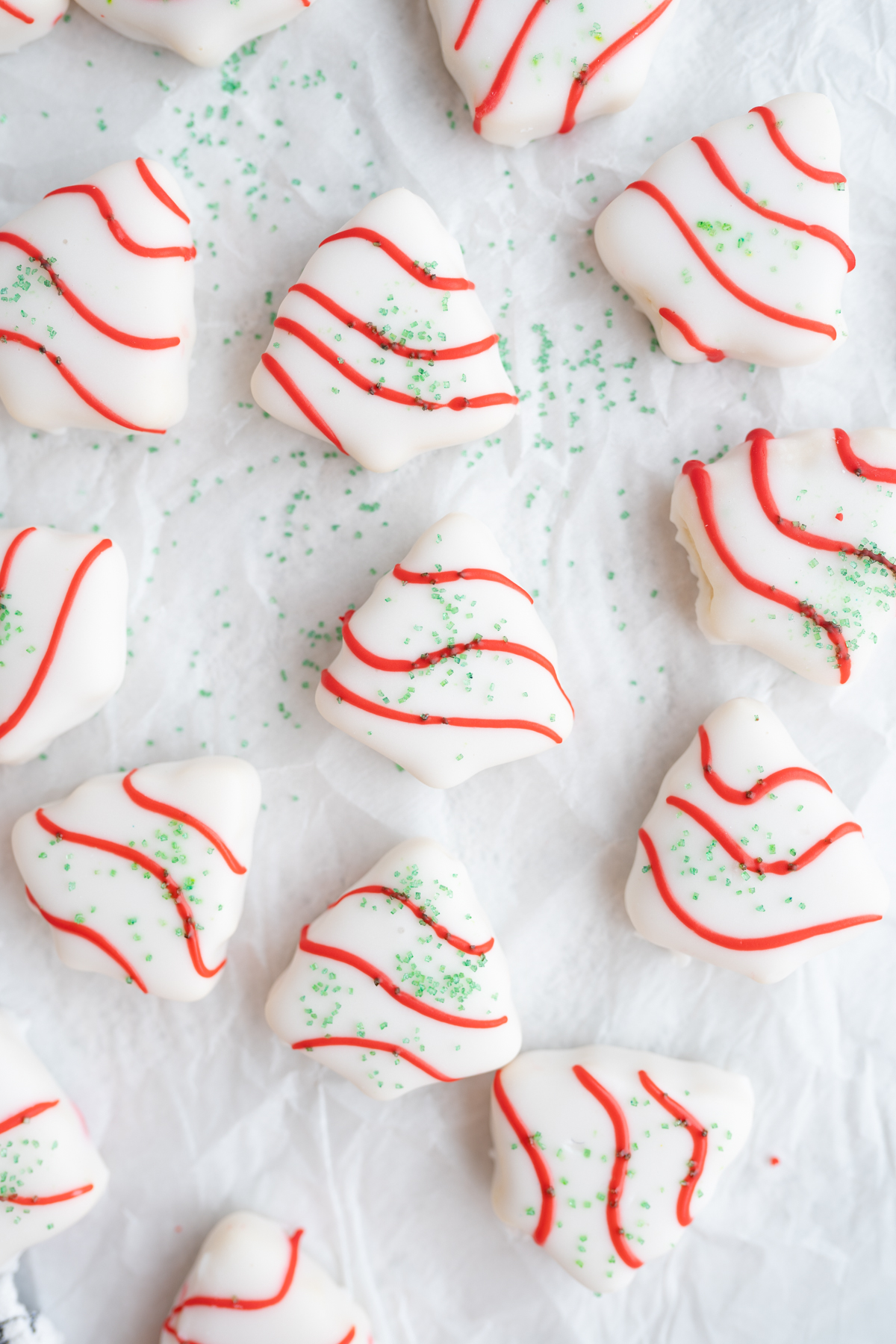Close up of tiny christmas tree sugar cookies on the counter. 