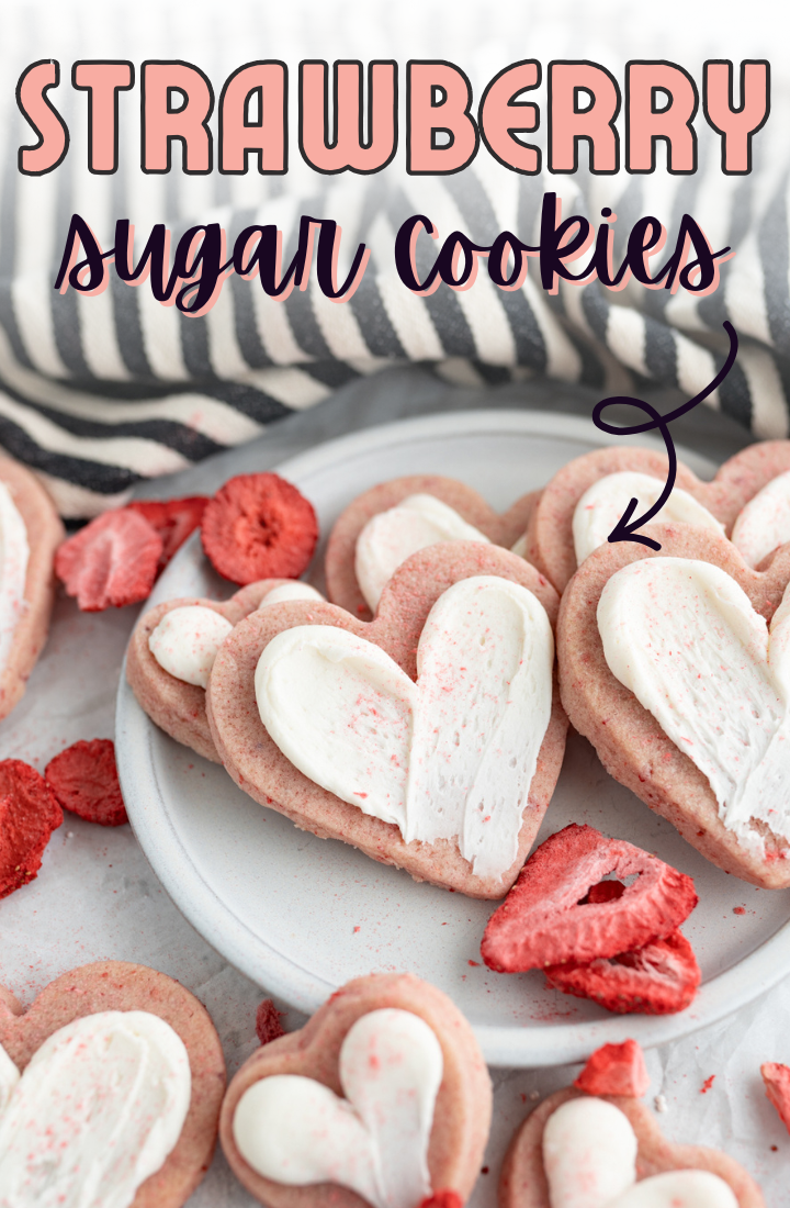 A plate of heart shaped strawberry sugar cookie.