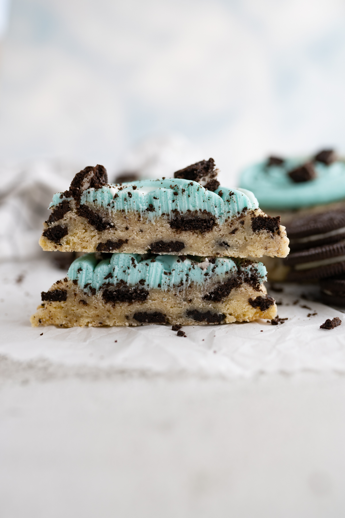 A blizzard inspired cookie cut in half to show marshmallow fluff and crushed oreos inside. 