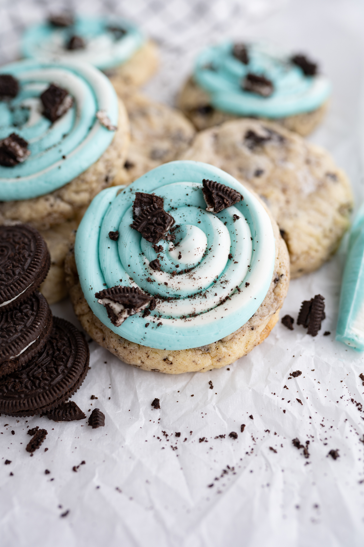 A cake batter cookies and cream cookie topped with frosting. 