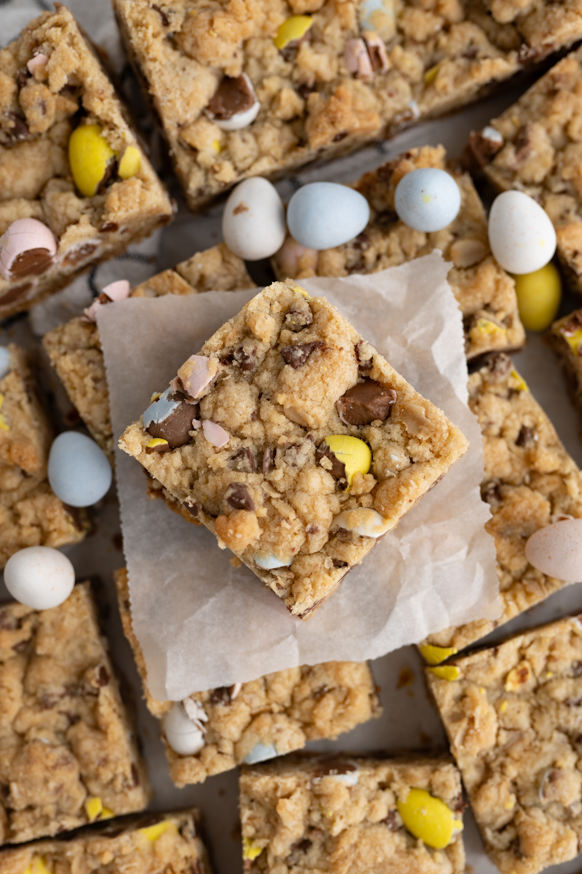 Aerial view of a Cadbury mini egg cookie bar with a brown sugar base, oats, and more chocolate chips. 