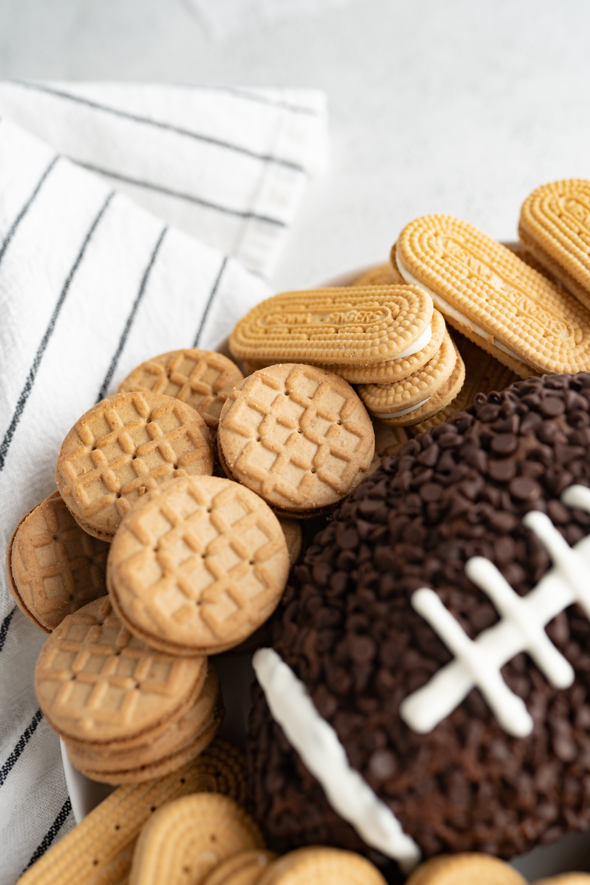 Side view of a chocolate cheeseball shaped like a football. 