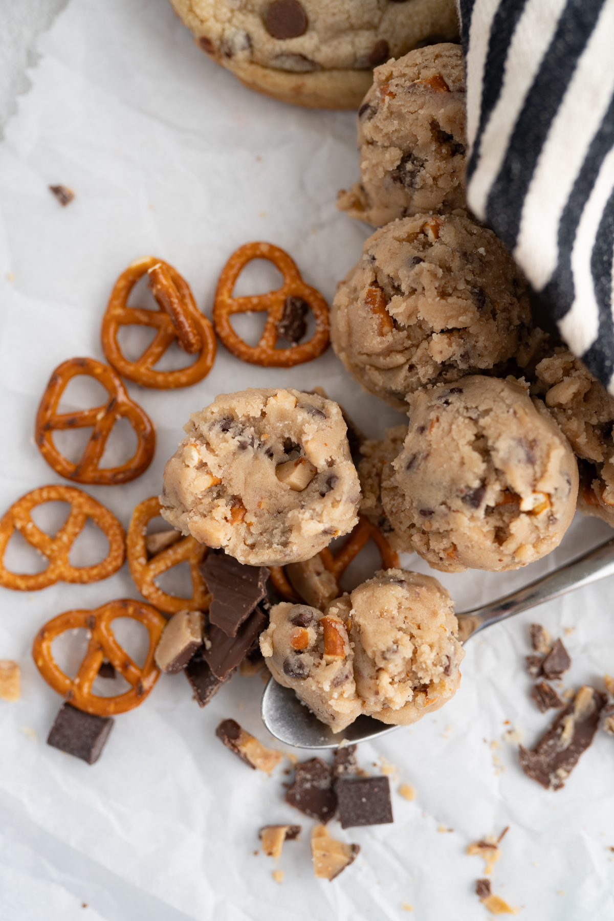 Aerial view of edible cookie dough filled with chocolate chips, pretzels, and toffee. 