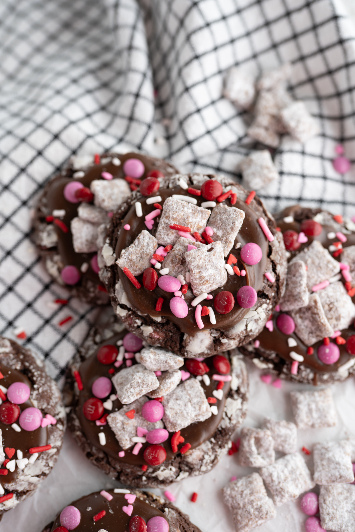 A pile of Valentine's crinkle cookies inspired by puppy chow. 