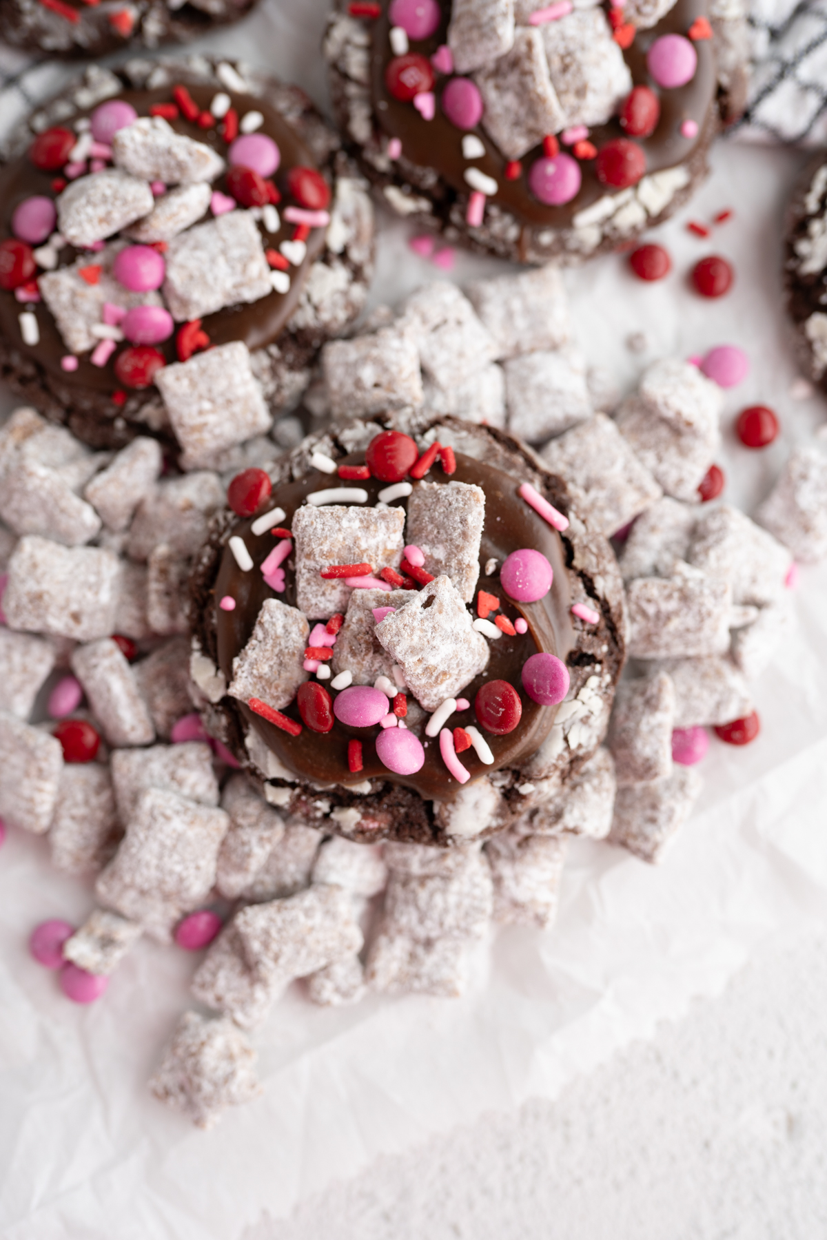 A chocolate Valentines cookie surrounded by puppy chow. 