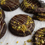 Close up of a stuffed Dubai cookie topped with pistachio.