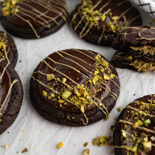 Close up of a stuffed Dubai cookie topped with pistachio.