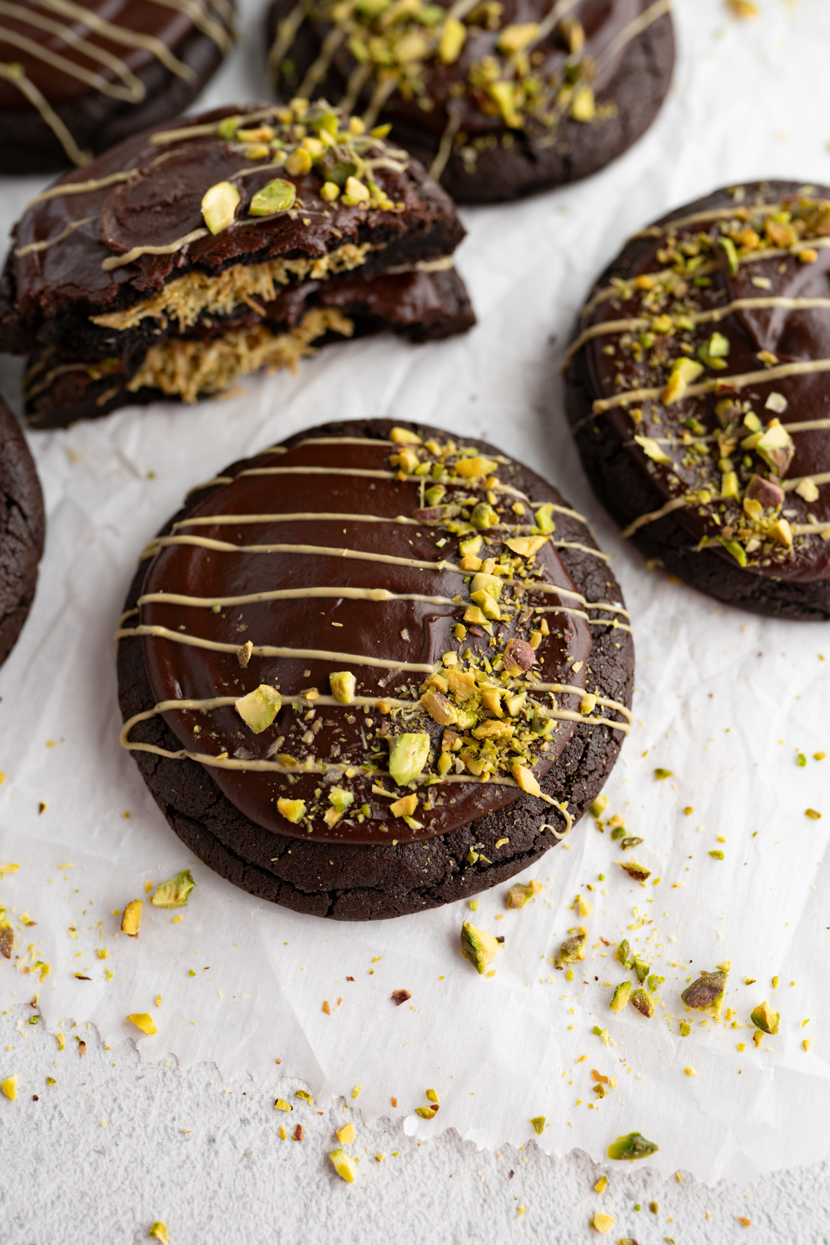Aerial view of a chocolate dubai cookie topped with pistachio and pistachio butter. 