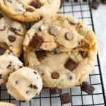 The ultimate chocolate chip cookie next to a ball of cookie dough filling.