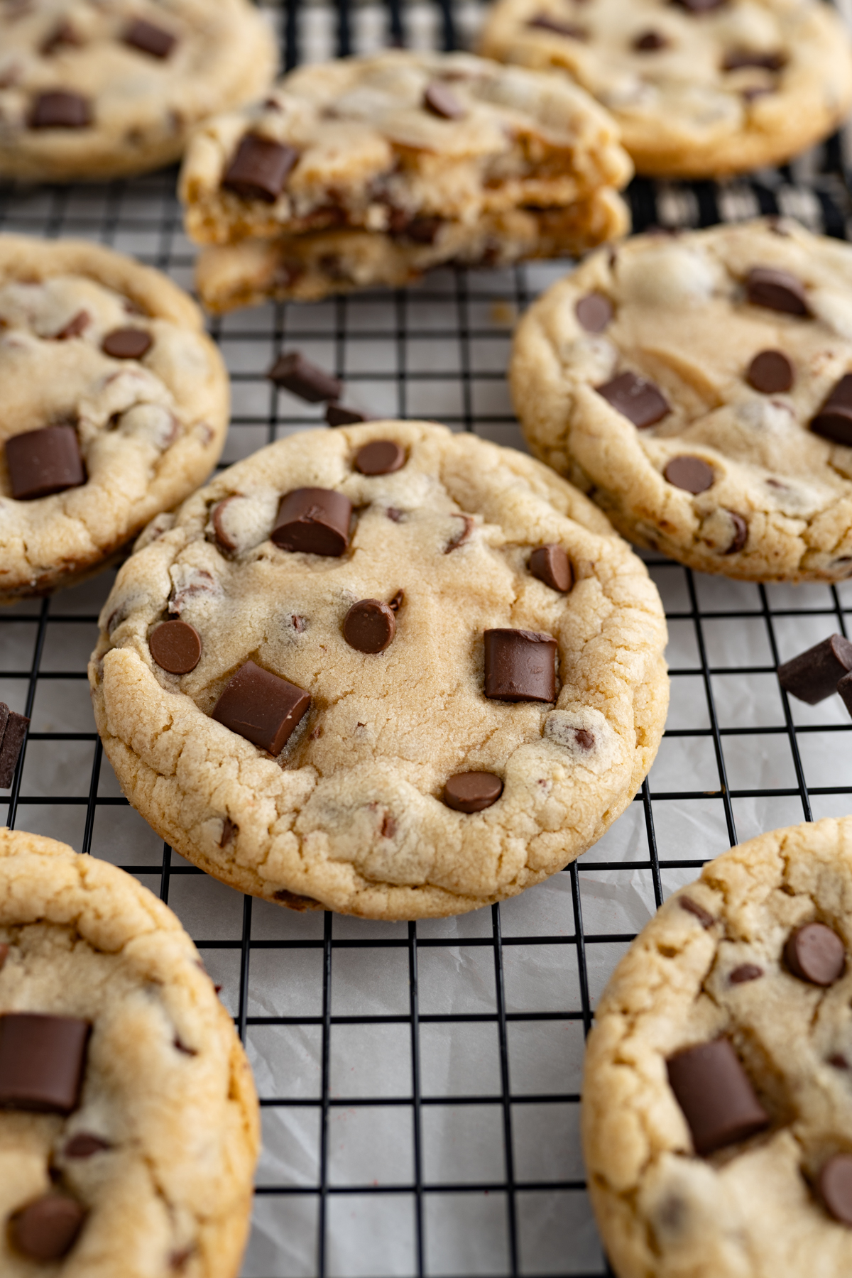 Side view of chocolate chip cookies with all types of chocolate and a cookie dough buttercream filling.
