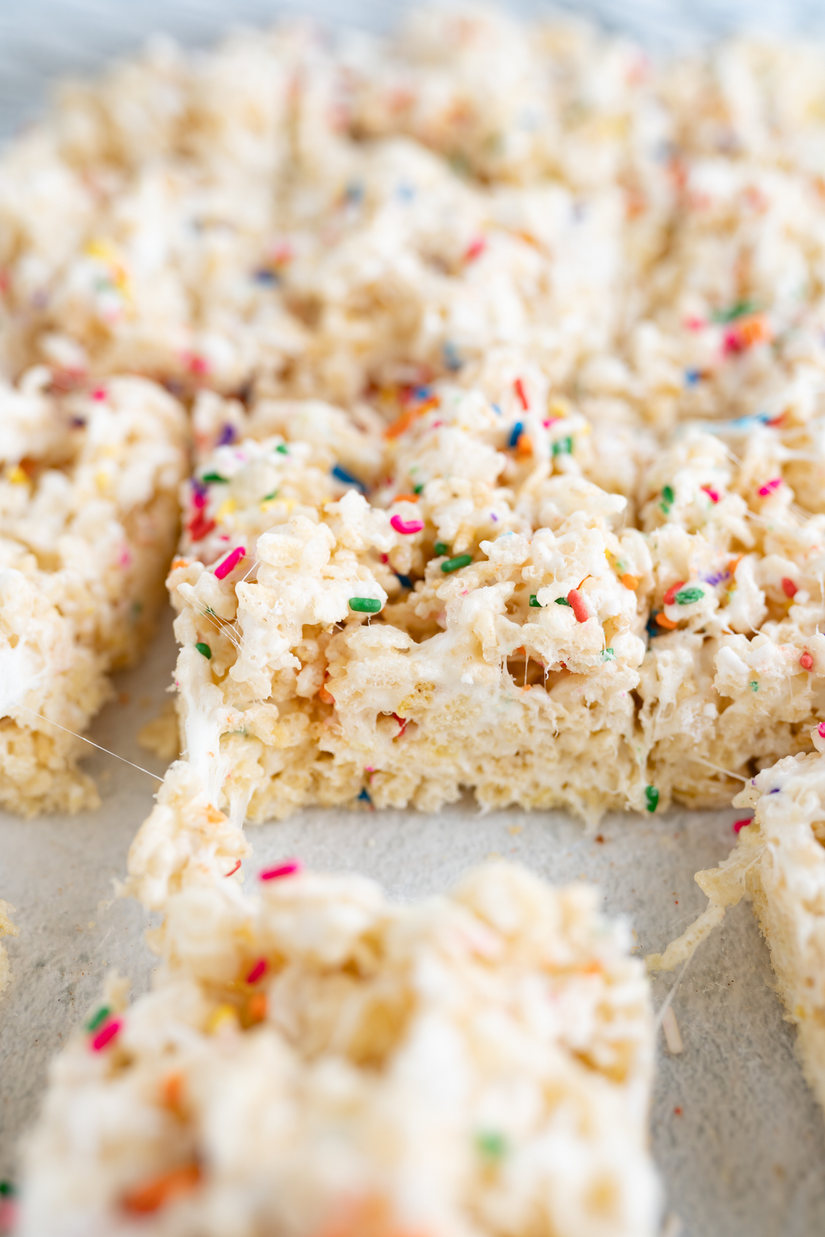 Side view of a cake batter rice krispie with sprinkles. 