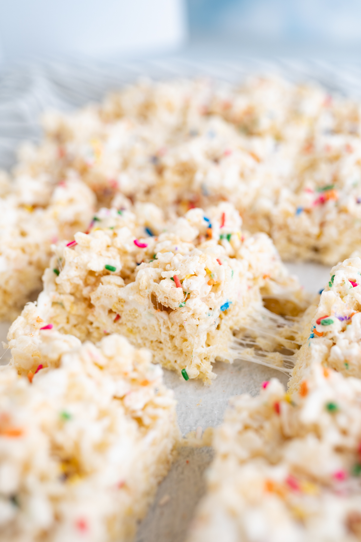Side view of a birthday rice krispie square separating from another square. 