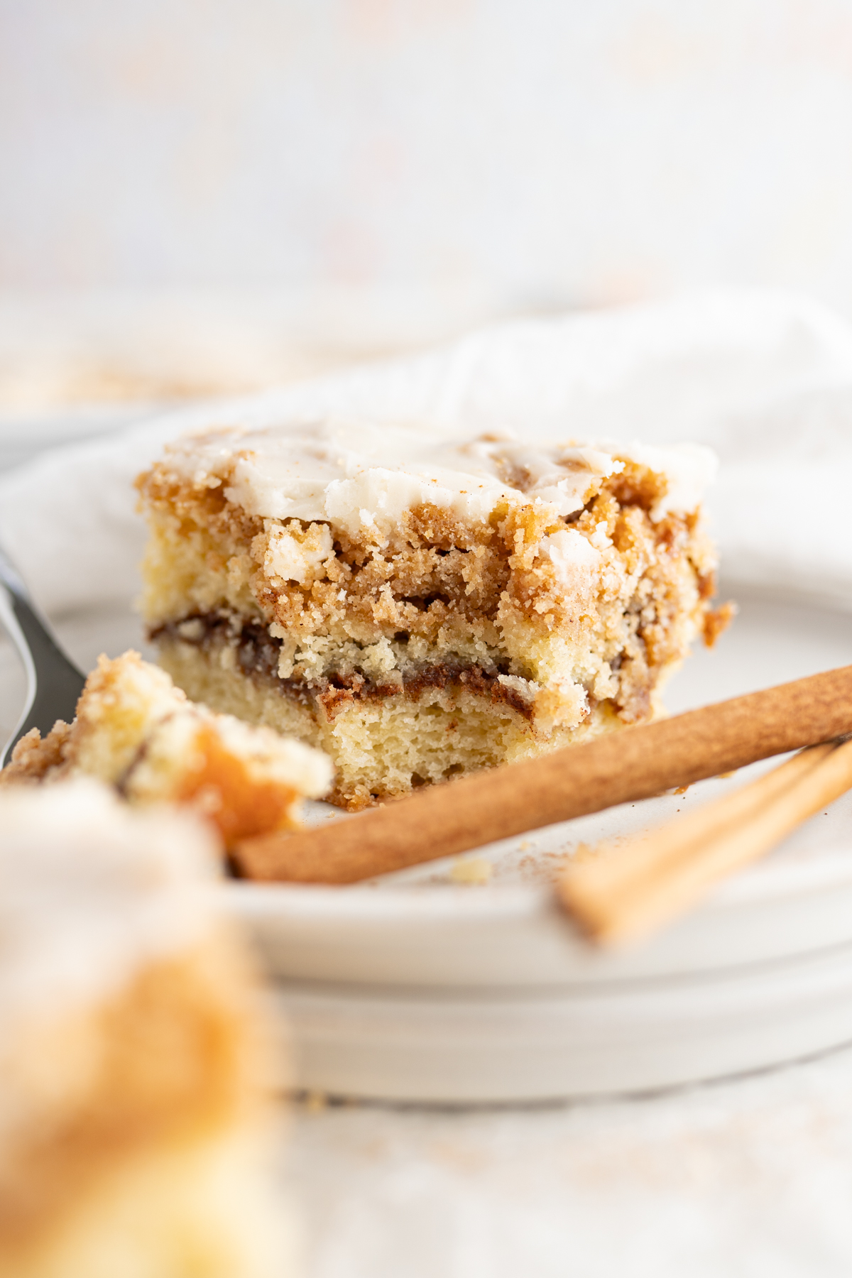 A single slice of cinnamon coffee cake on a plate.