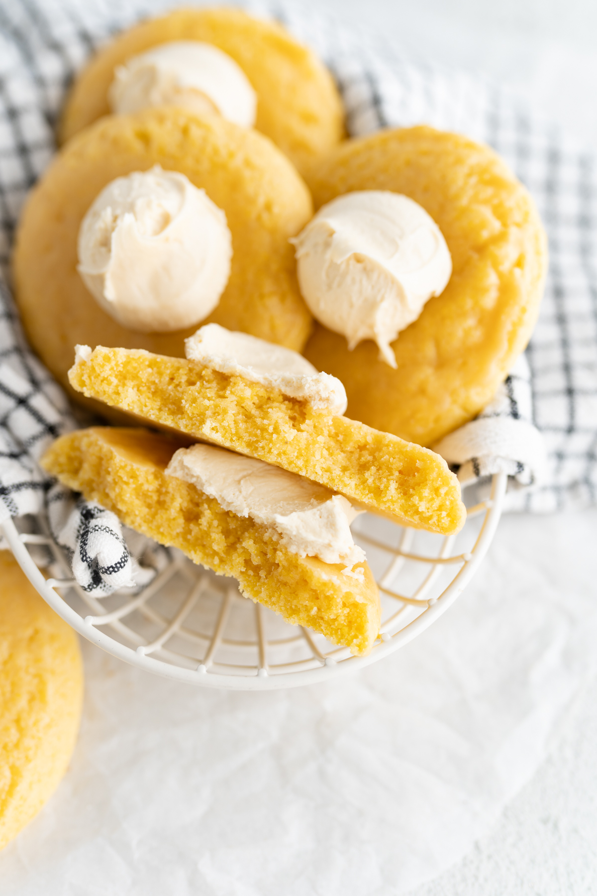 A cornbread cookie broken in half to reveal a soft interior. 