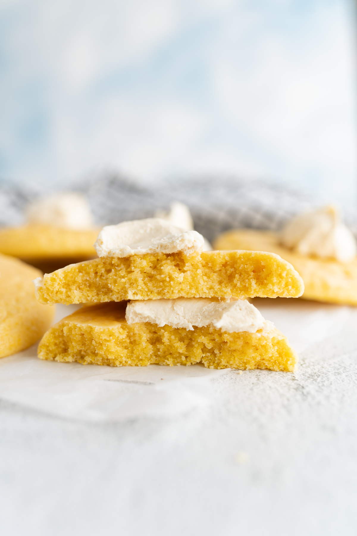 Side view of a cornbread-inspired cookie topped with honey glaze and honey buttercream. 