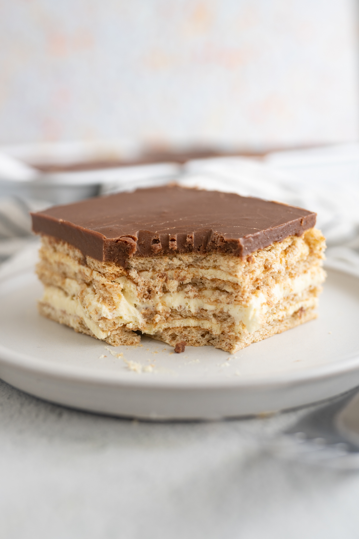 A no bake eclair square with a bite taken out of it. 
