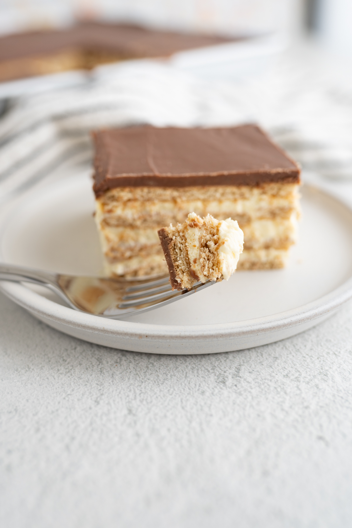 A bite of no bake chocolate eclair bars. 