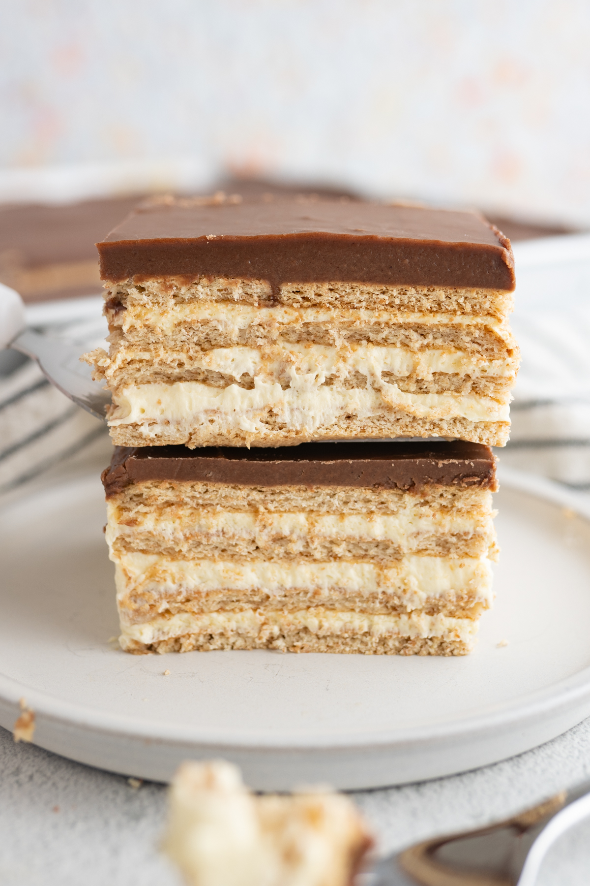 Two squares of no bake eclairs stacked. 
