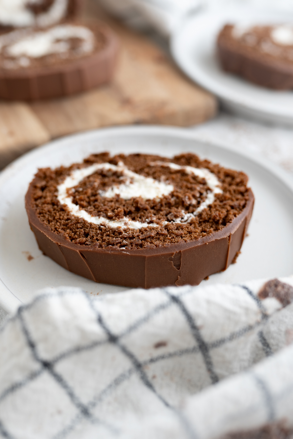 Side view of a chocolate swiss roll cut to show the swirl. 