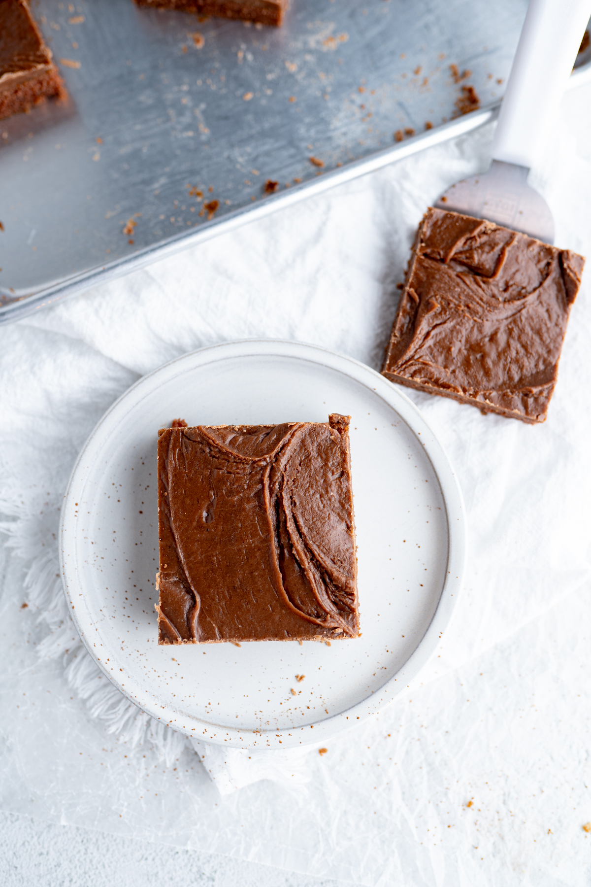 Aerial view of a texas sheet cake slice served on a plate. 