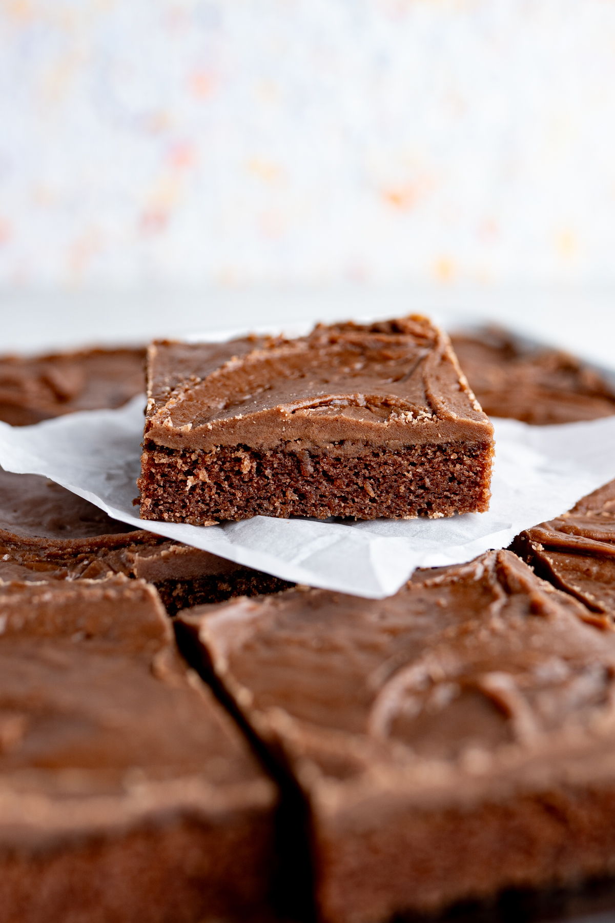 Side view of a slice of texas sheet cake. 