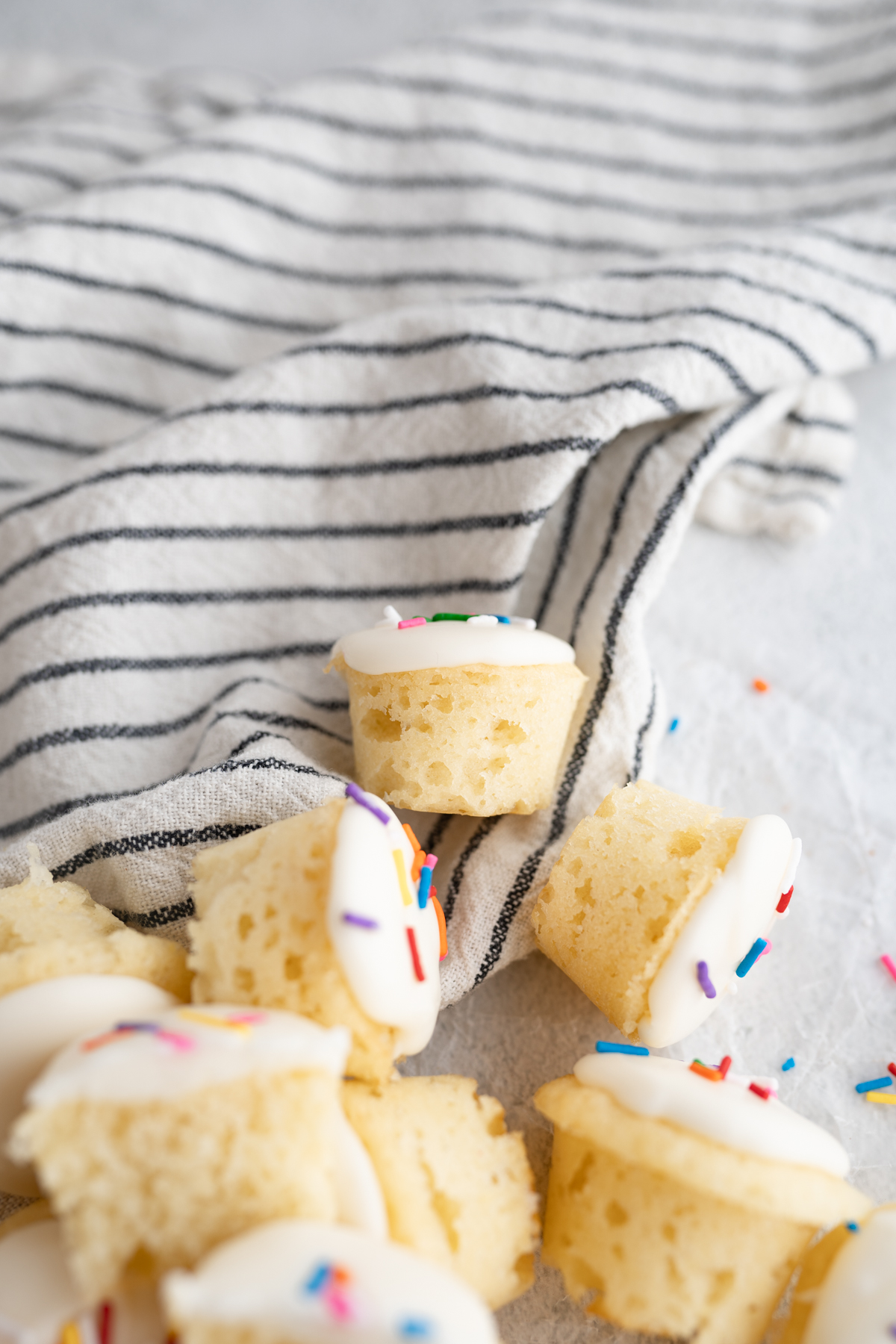 A mini vanilla cupcake bite on a counter. 