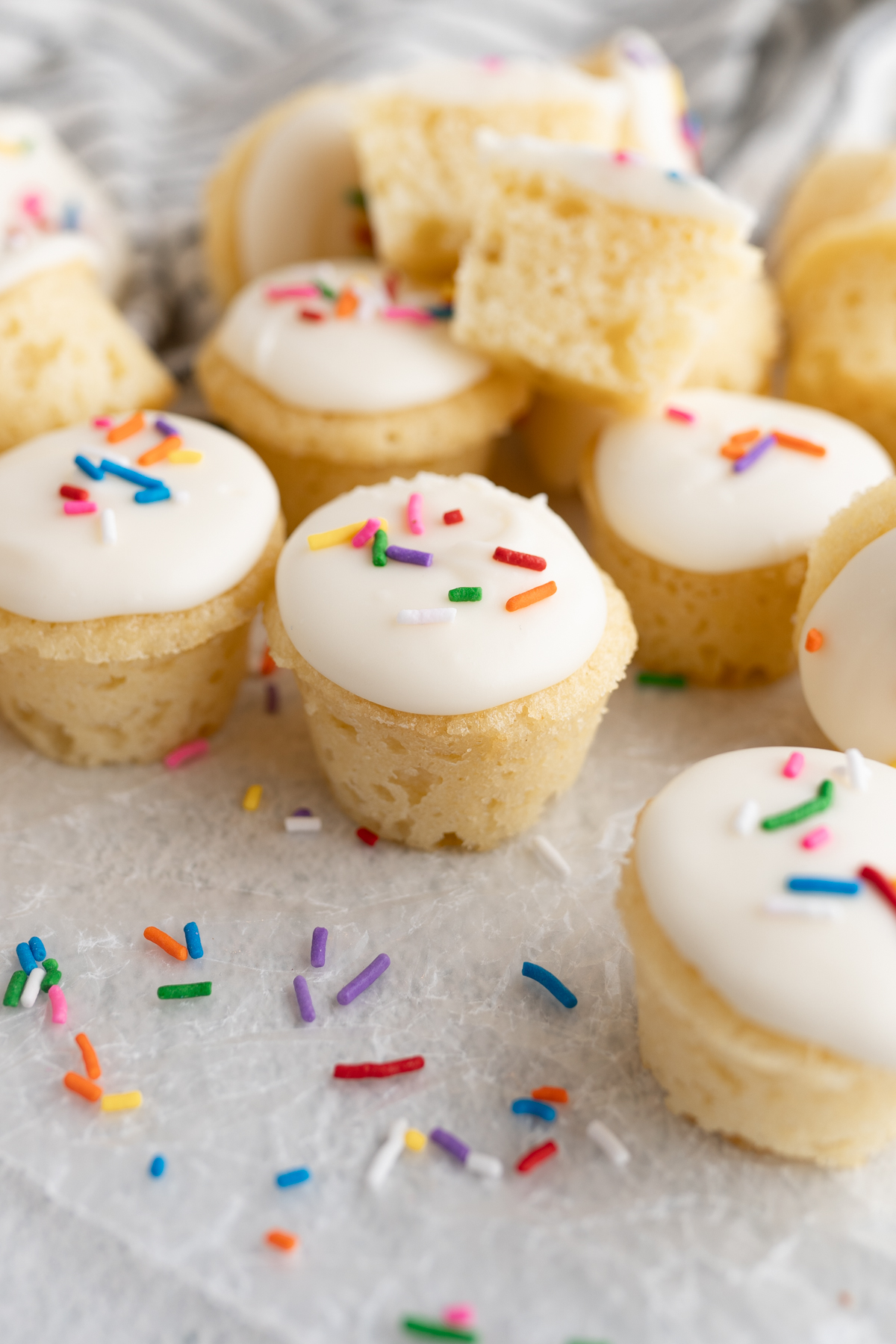 Close up of a pile of sprinkles and mini vanilla cake bites. 