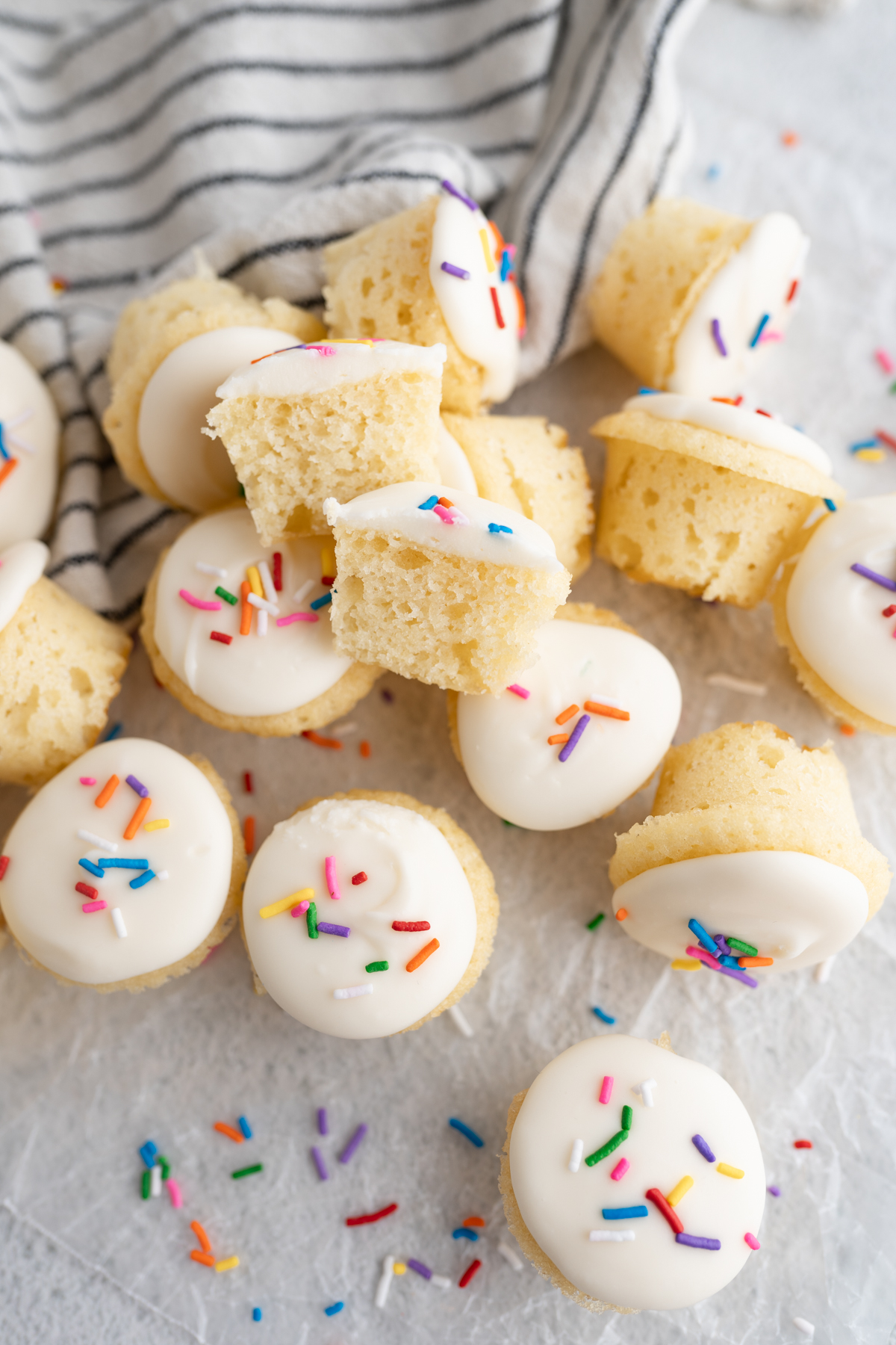 Vanilla cake bites with vanilla frosting and sprinkles. 