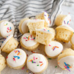 A pile of frosted vanilla cake bites.