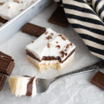 A chocolate lush with a forkful out of it.